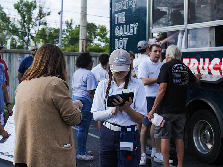employee at food truck taking order